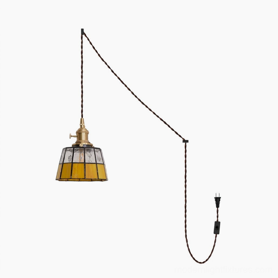 Keito stained glass pendant fixture showing brass hardware, hand-cut amber and clear glass panels with black leaded solder lines and braided cord on white background