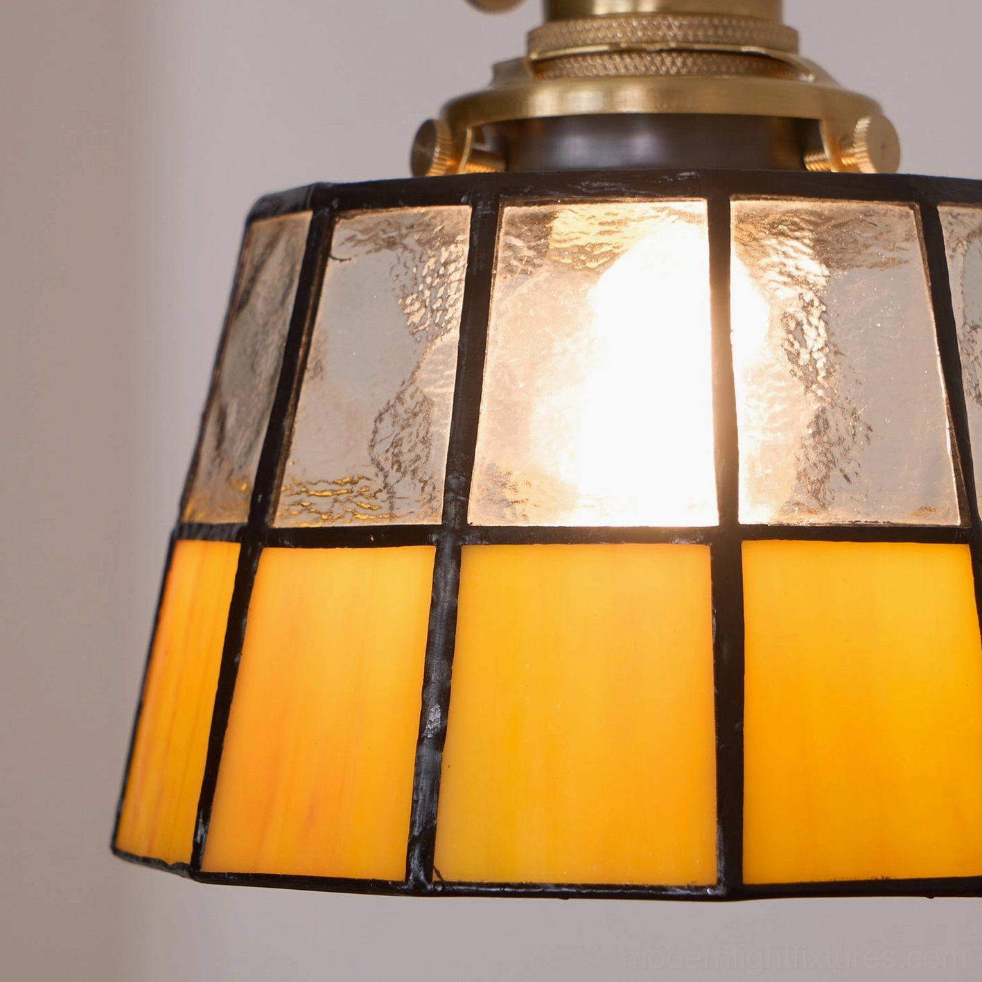 Close-up of Keito stained glass shade showing textured glass panels with black brass grid framing