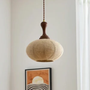 Kenso linen pendant light unlit frontal view with vintage walnut wood fixture and light brown fabric shade