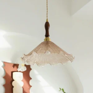Kenyata pendant lamp three-quarter view showing ruffled glass shade detail in arched wall interior setting with natural light