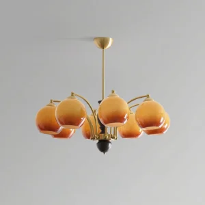 Modern chandelier with curved brass arms and gradient amber glass globes, minimalist interior design