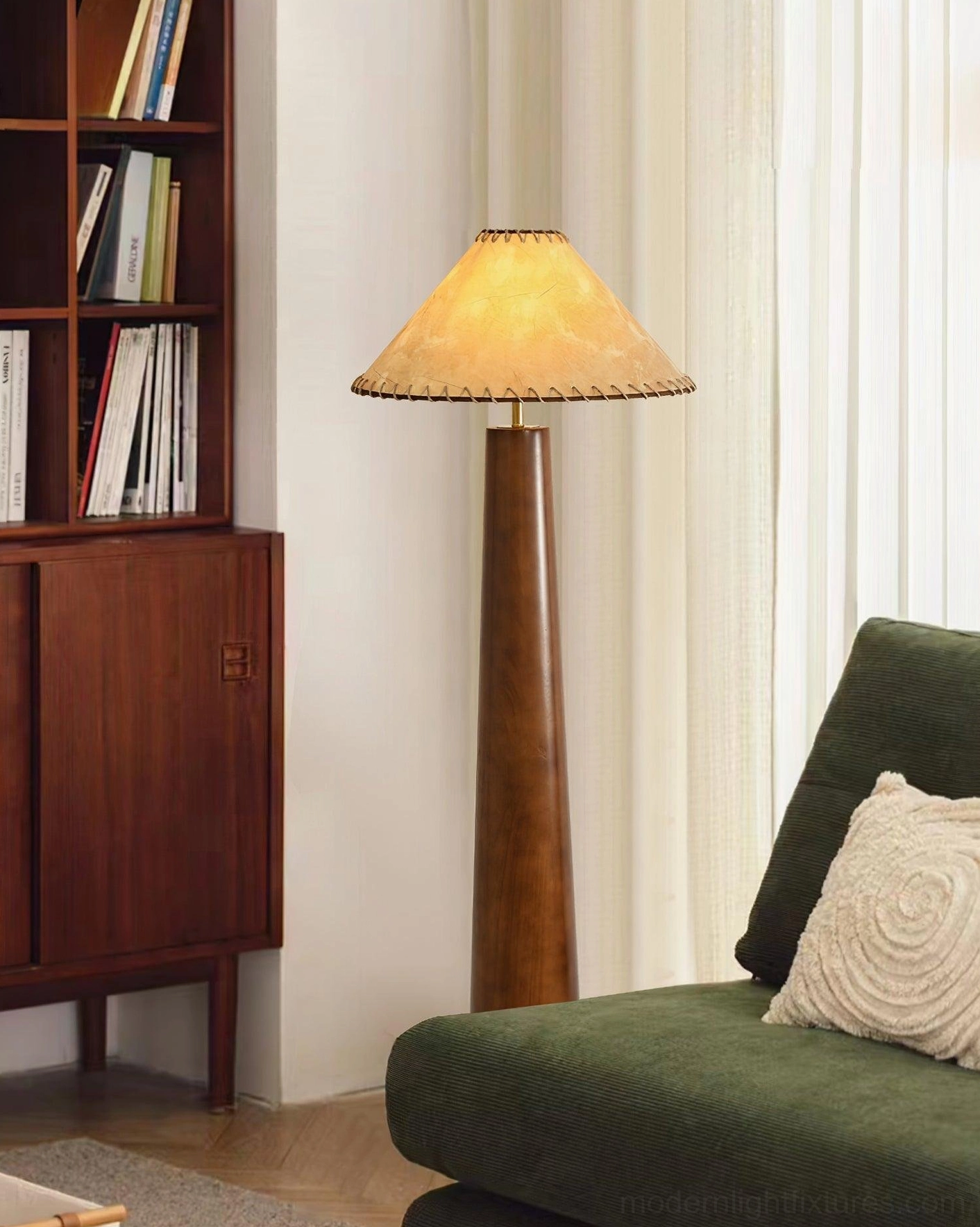 Kibo mid-century floor lamp in living room with green sofa and bookshelf, warm natural vintage style lighting