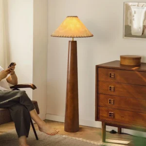 Kibo mid-century wood floor lamp in living room setting with wooden dresser and lounge chair, warm ambient lighting