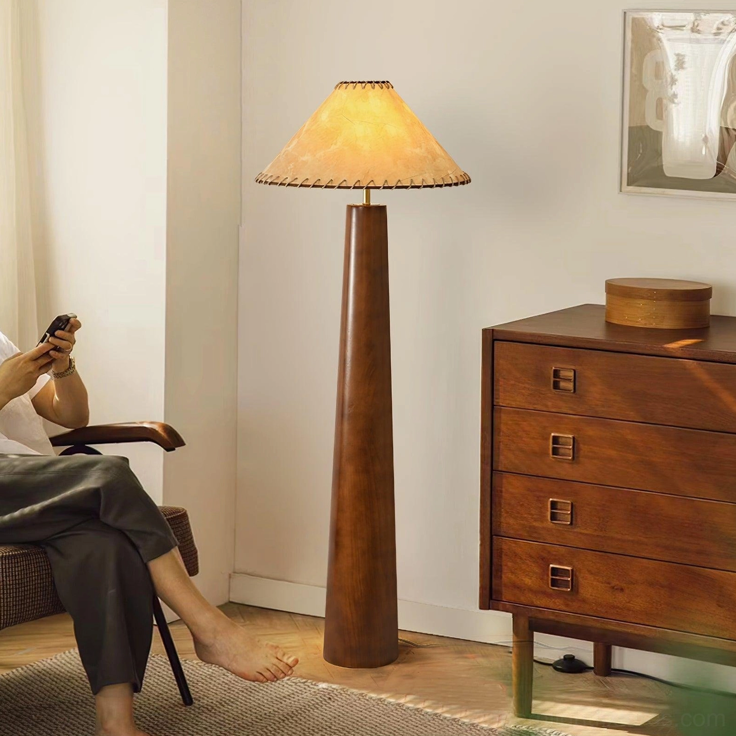 Kibo mid-century wood floor lamp in living room setting with wooden dresser and lounge chair, warm ambient lighting