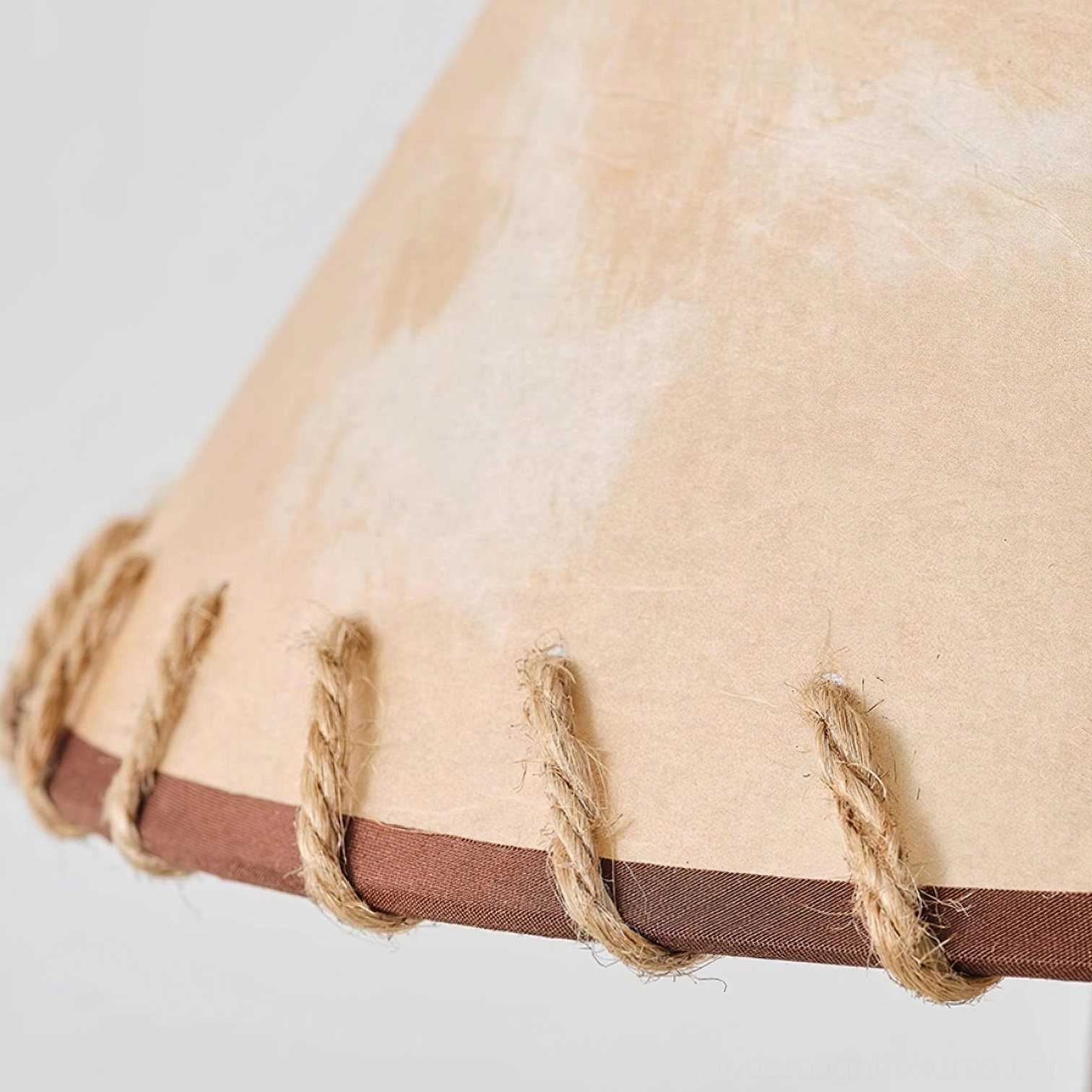 Kibo floor lamp in scandinavian minimalist interior, hand-knotted jute shade creating warm atmospheric lighting