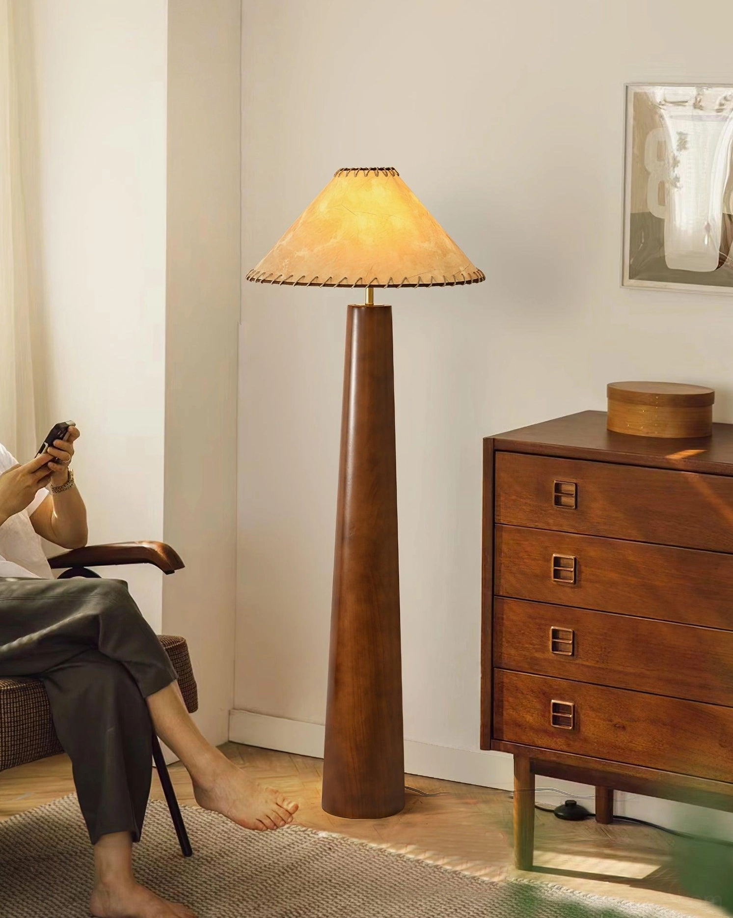 Kibo jute-shaded wood floor lamp in traditional living room with wooden furniture, warm vintage aesthetic