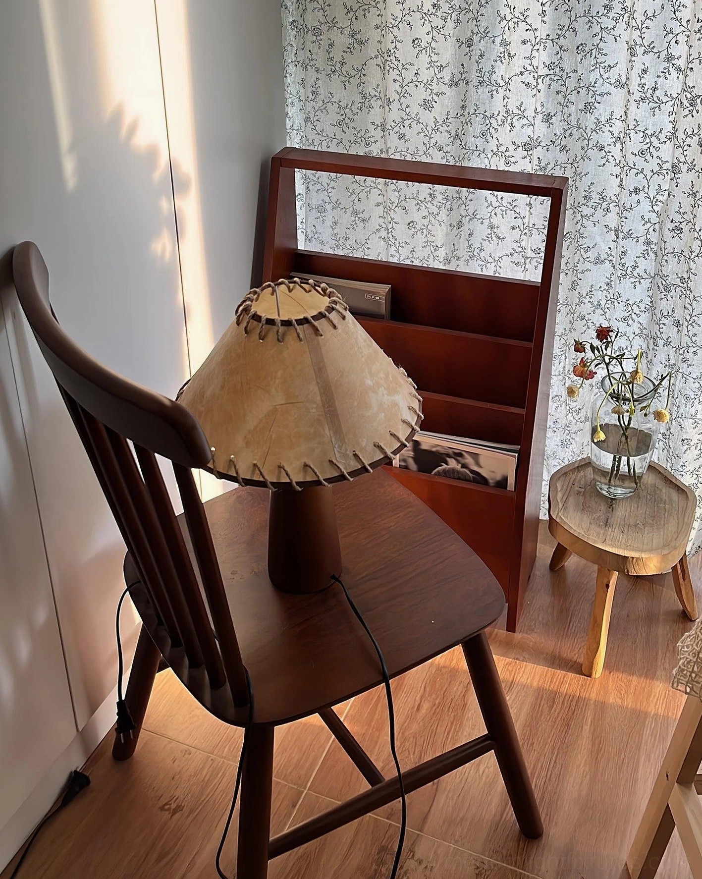 Kibo wood table lamp with warm light output in cozy bedroom corner with rustic farmhouse decor style