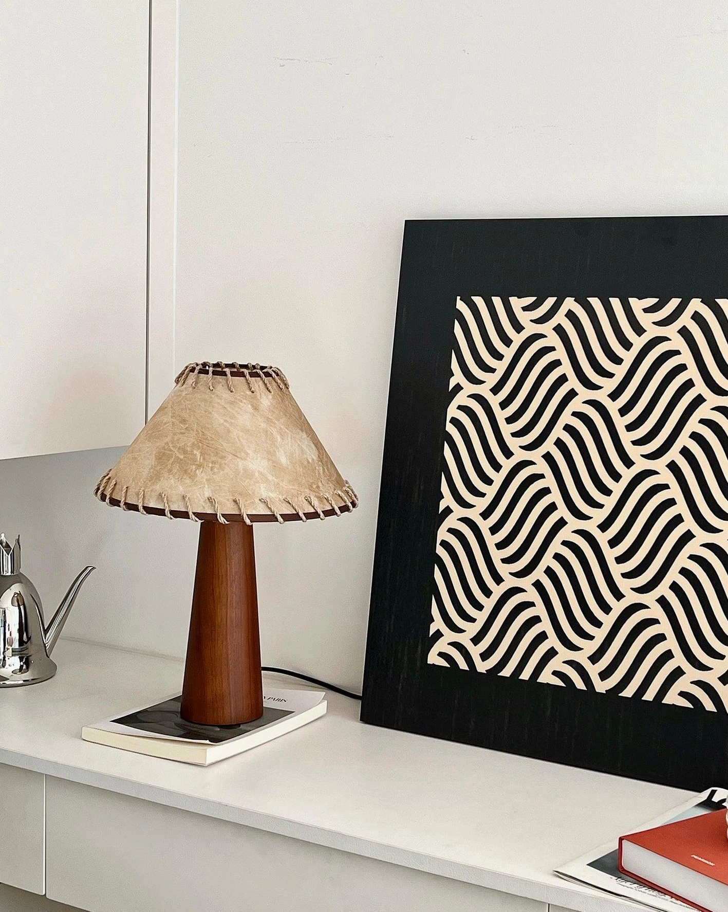 Kibo wood table lamp with jute shade and walnut base, close-up detail showing hand-stitched pattern and craftsmanship