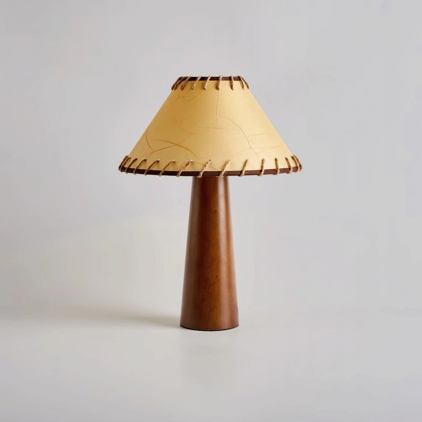 Kibo wood table lamp in warm walnut and beige color options with conical jute shade and solid wood construction