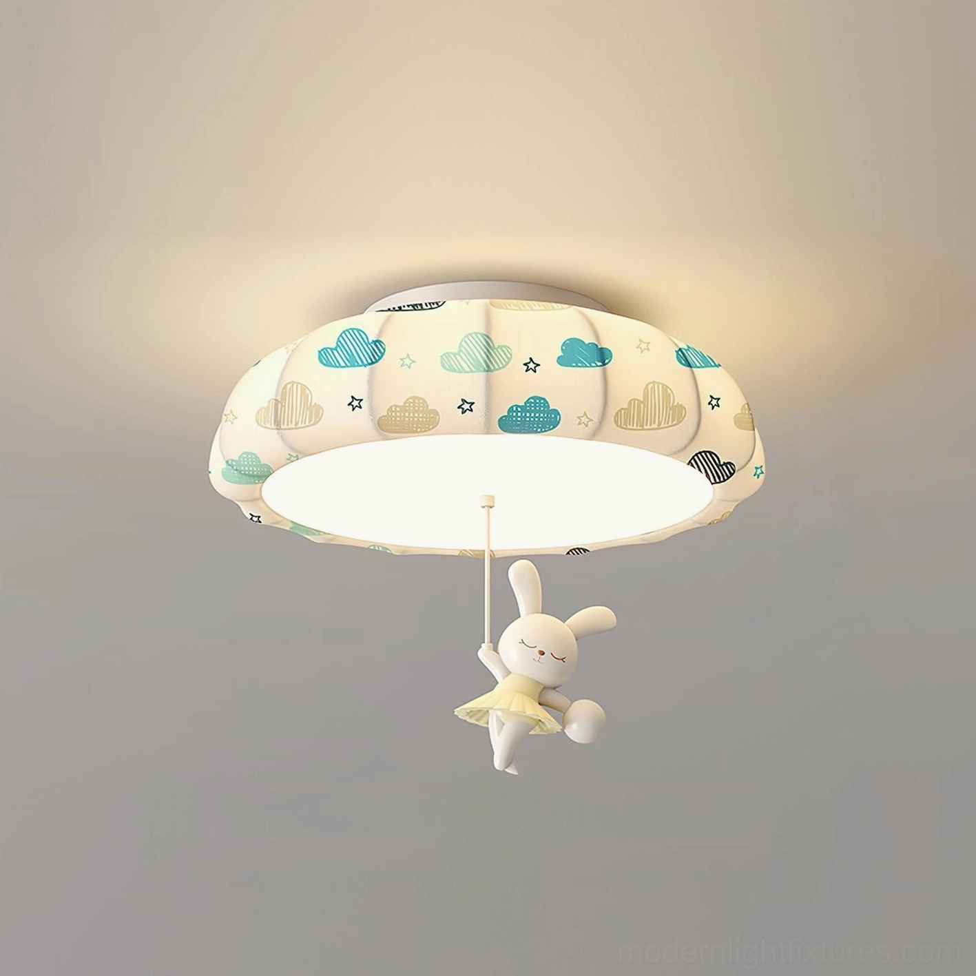 Pumpkin ceiling light fixture with blue accent prints and hanging rabbit plush ornament, shown in children's bedroom setting with warm ambient glow