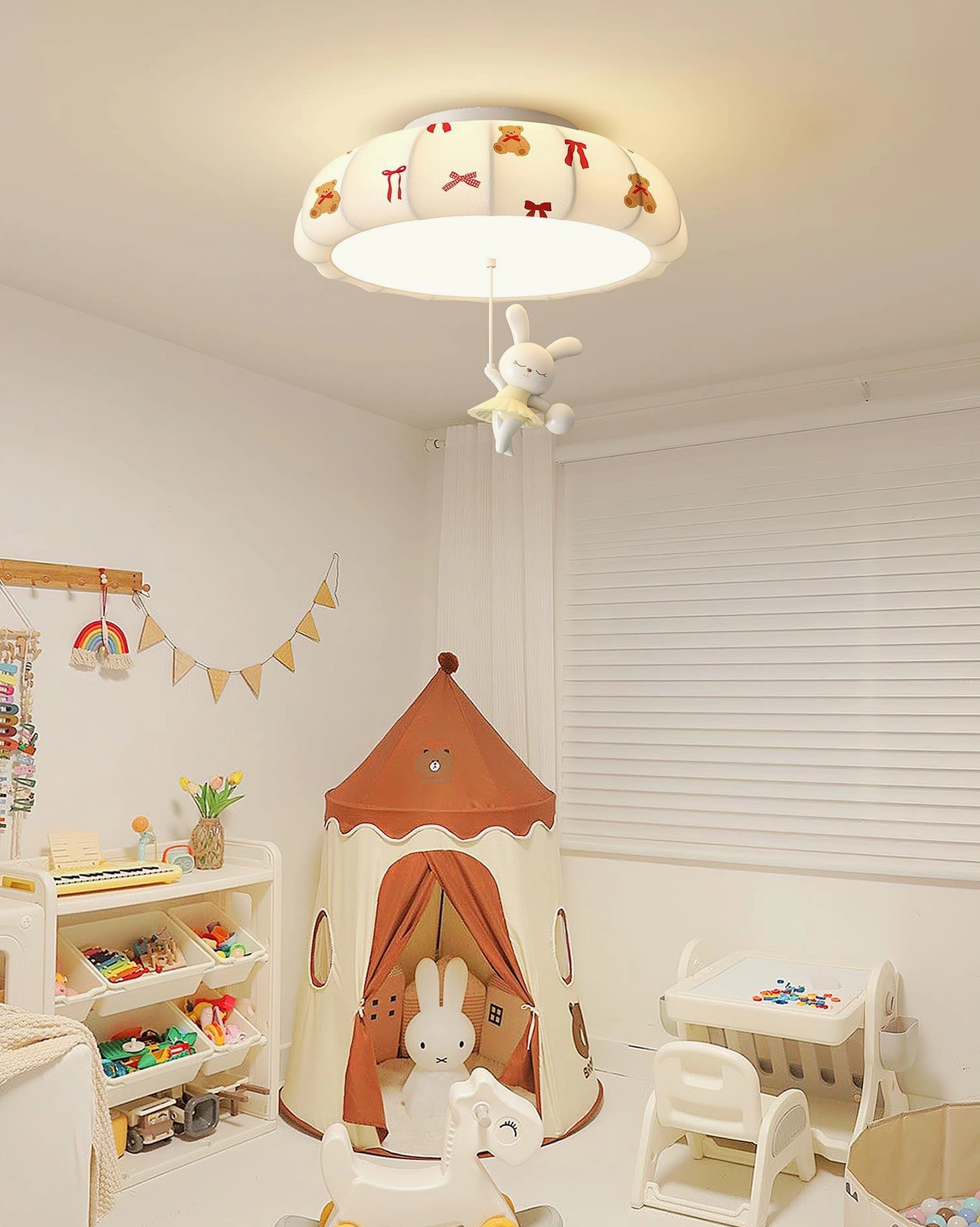 Kids' playroom interior with pumpkin ceiling light fixture mounted above play tent, showing off-white shade with bear and bow prints and hanging rabbit