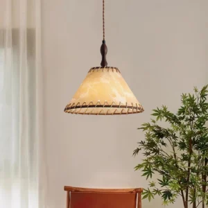 Kiko pendant lamp installed in cozy rustic interior with green plants and warm decor styling