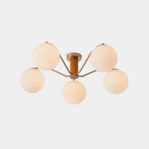 Kina 5-head modern ceiling light fixture with ribbed opal glass spheres and walnut wood arms in studio front view