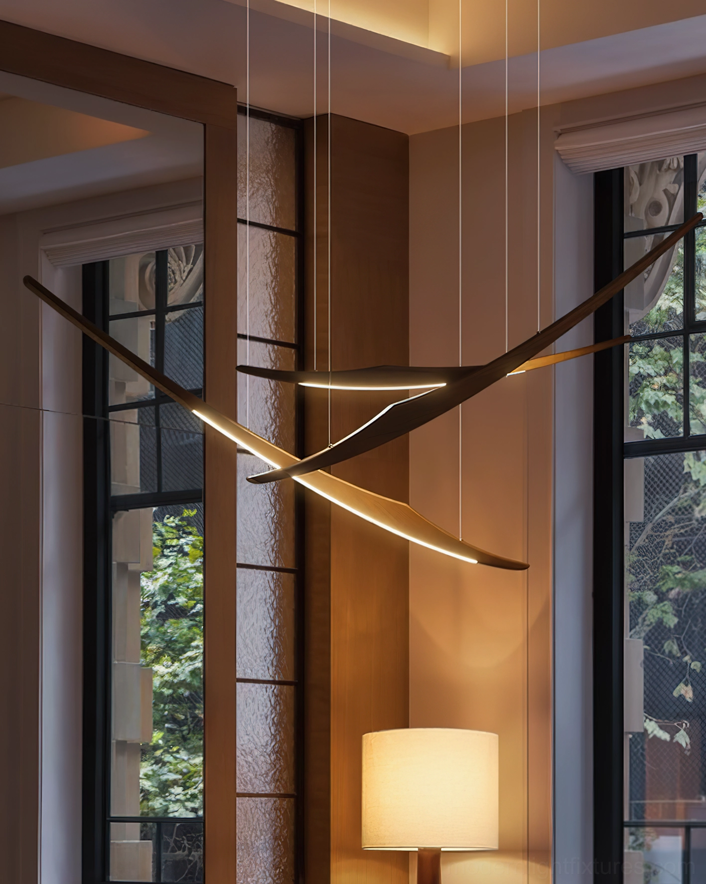 Modern wooden arc pendant chandelier installed in residential room with natural light from windows