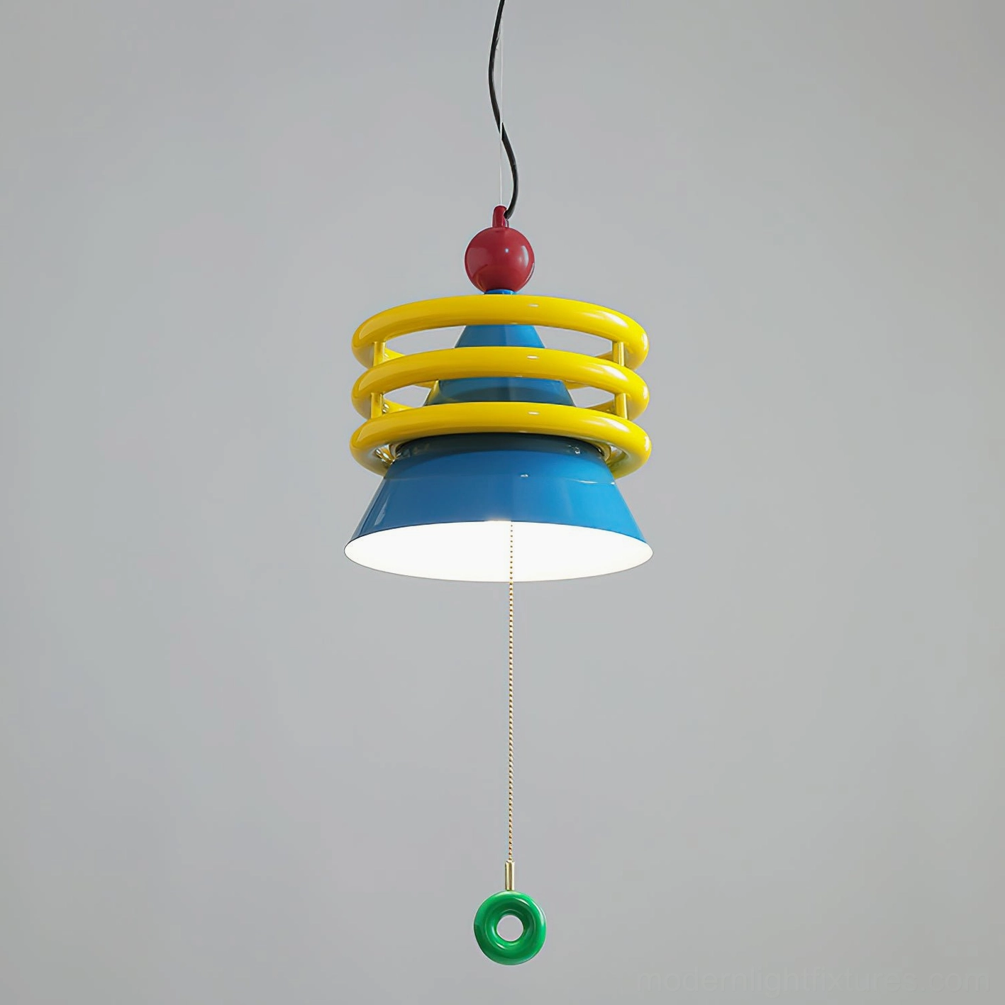 Kinetica pendant lamp illuminated with blue cone shade glowing, yellow coil rings, and green hanging pull switch - studio lighting