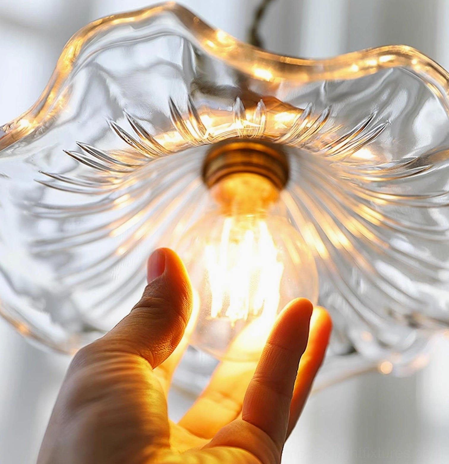 Kinney amber glass fluted pendant light casting warm glow in modern interior space