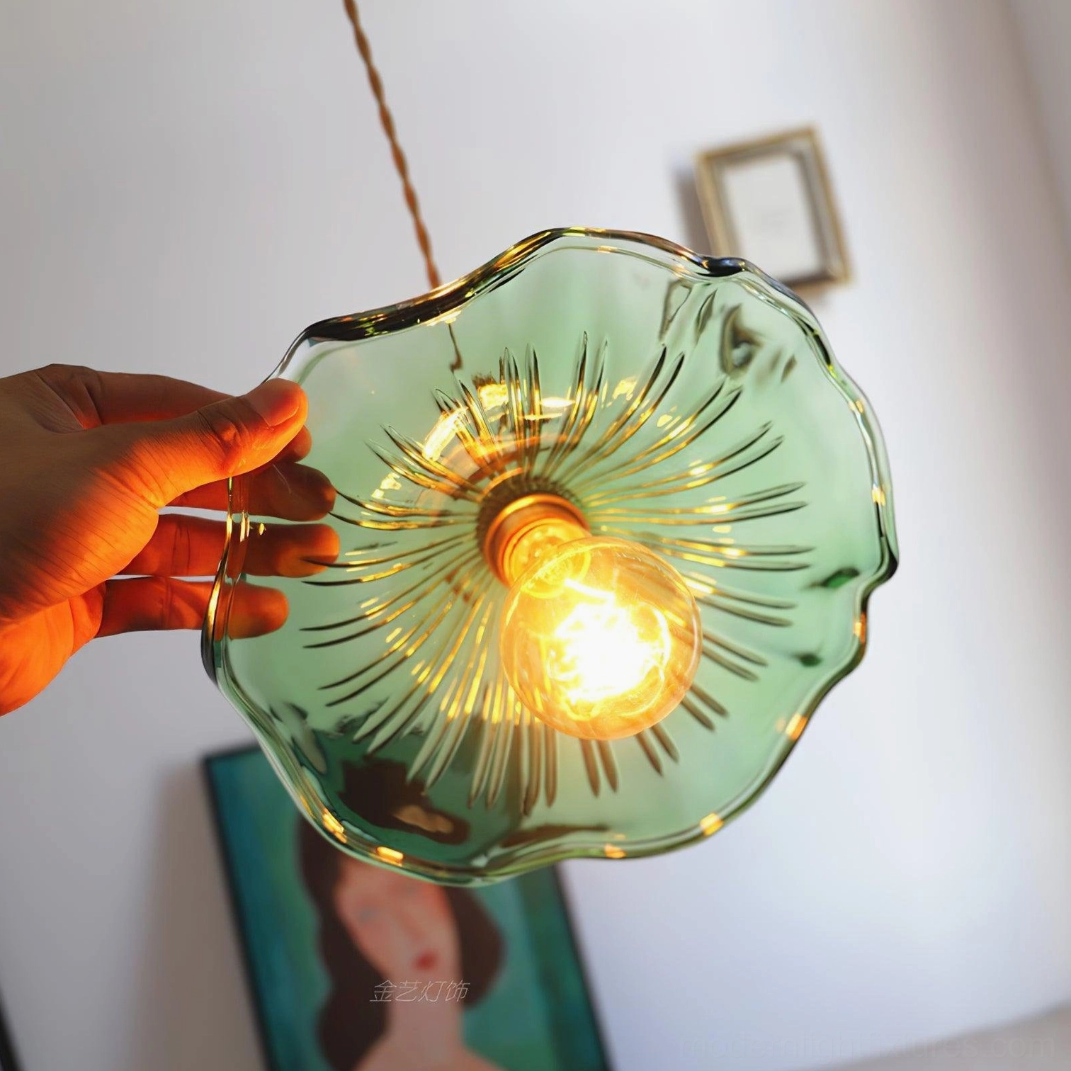 Kinney green fluted glass pendant lamp glowing indoors with visible ribbed texture and warm bulb light