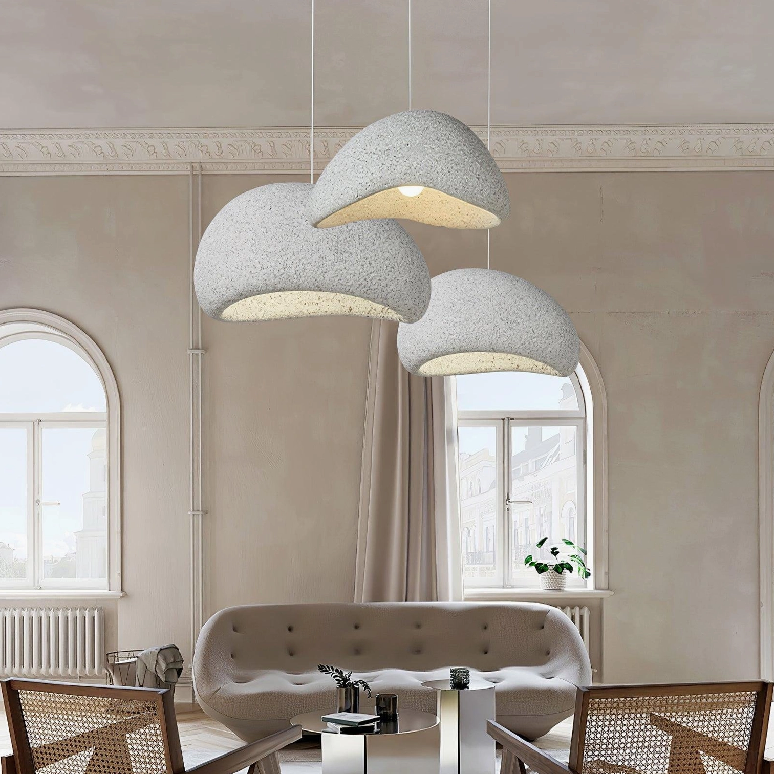 Set of three Kioto wabi-sabi pendant lights suspended in minimalist living room with arched window