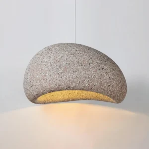 Close-up texture detail of Kioto pendant lamp showing fine granite-like speckled surface and warm illumination
