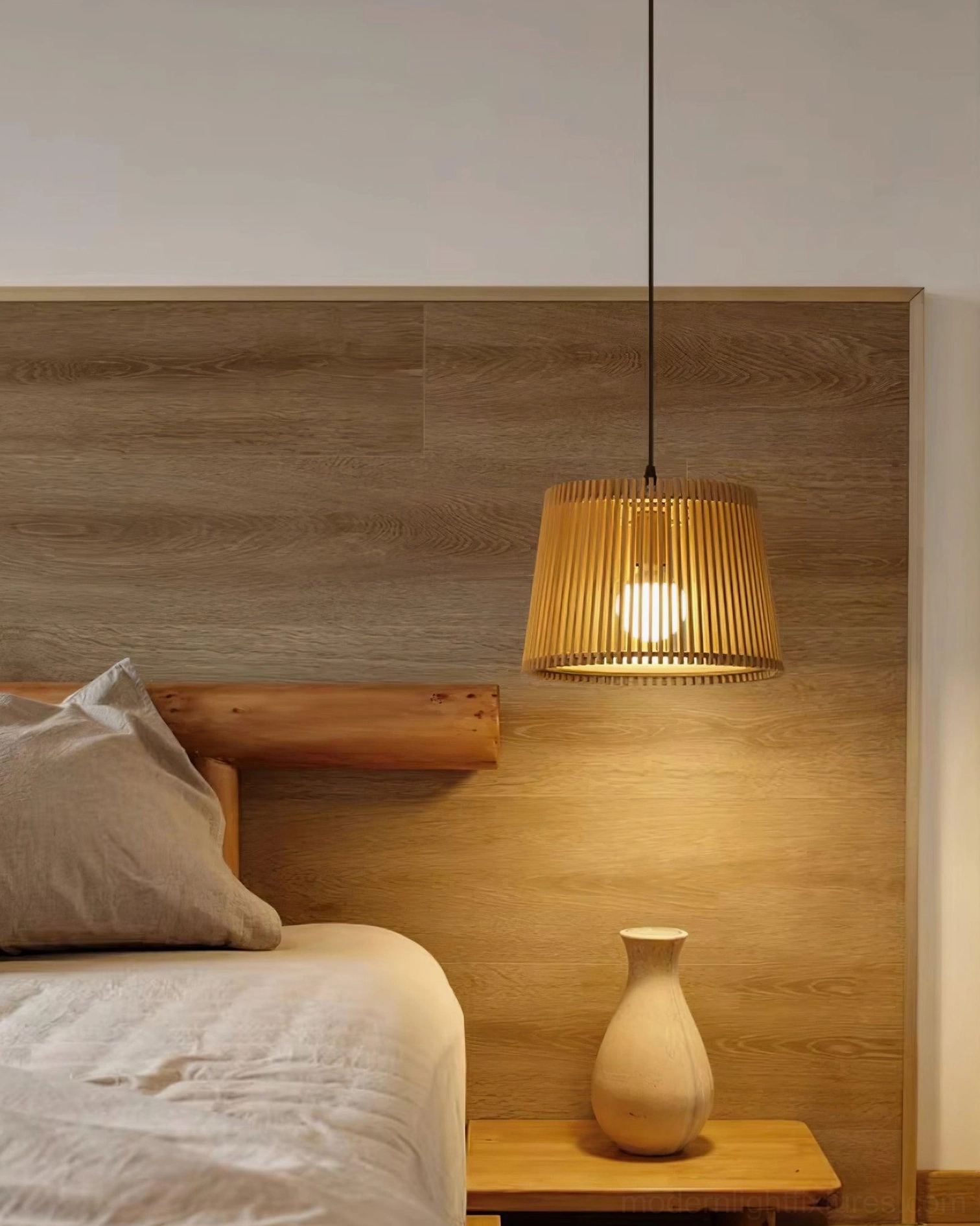 Kitami wood slatted pendant lamp casting warm light in bedroom with wooden headboard