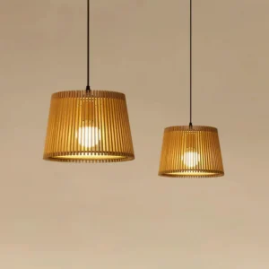 Two Kitami pendant lights with warm glow hanging in modern interior setting with neutral background