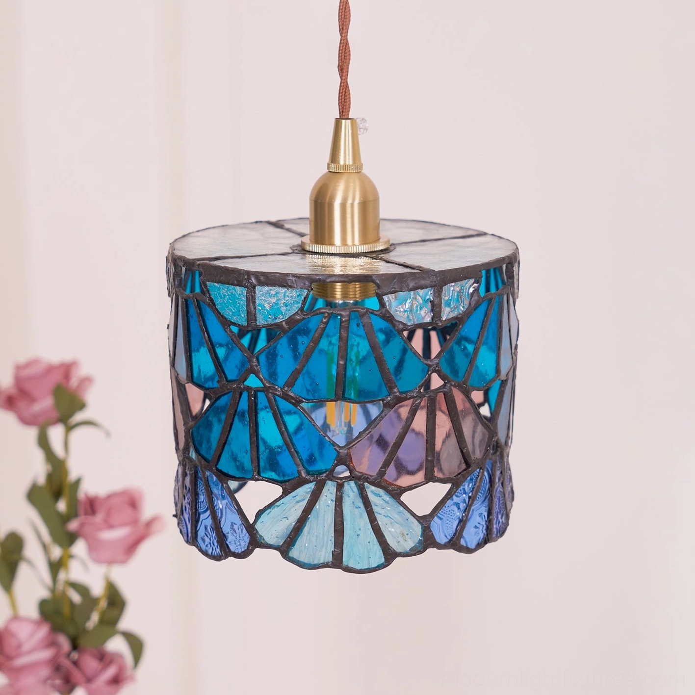 Compact stained glass pendant light in residential kitchen nook creating colored light ambiance
