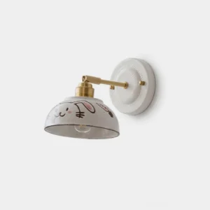 Kitora hand-painted ceramic wall sconce with adjustable brass arm, rabbit pattern, gold and white finish, front studio view