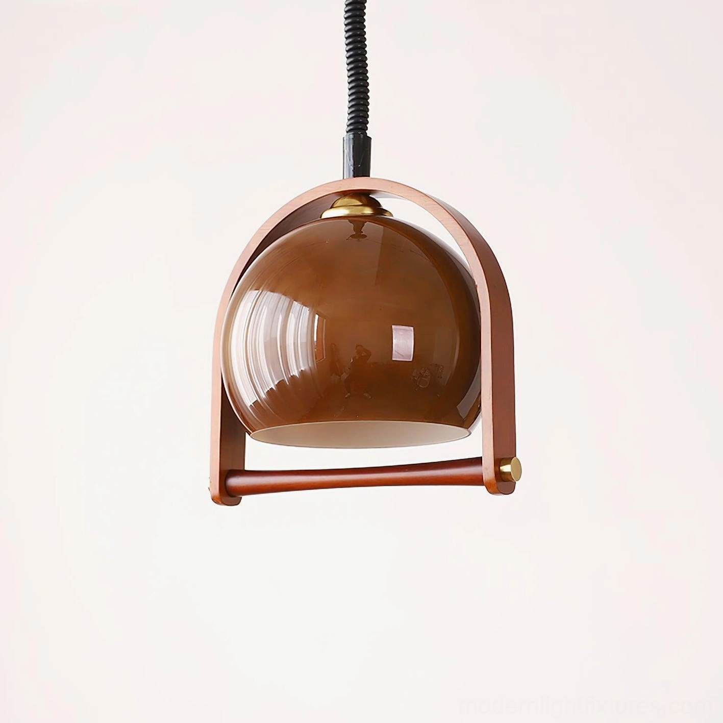 Kleine adjustable pendant light featuring brown glossy glass shade with wooden arched frame and black spiral cord