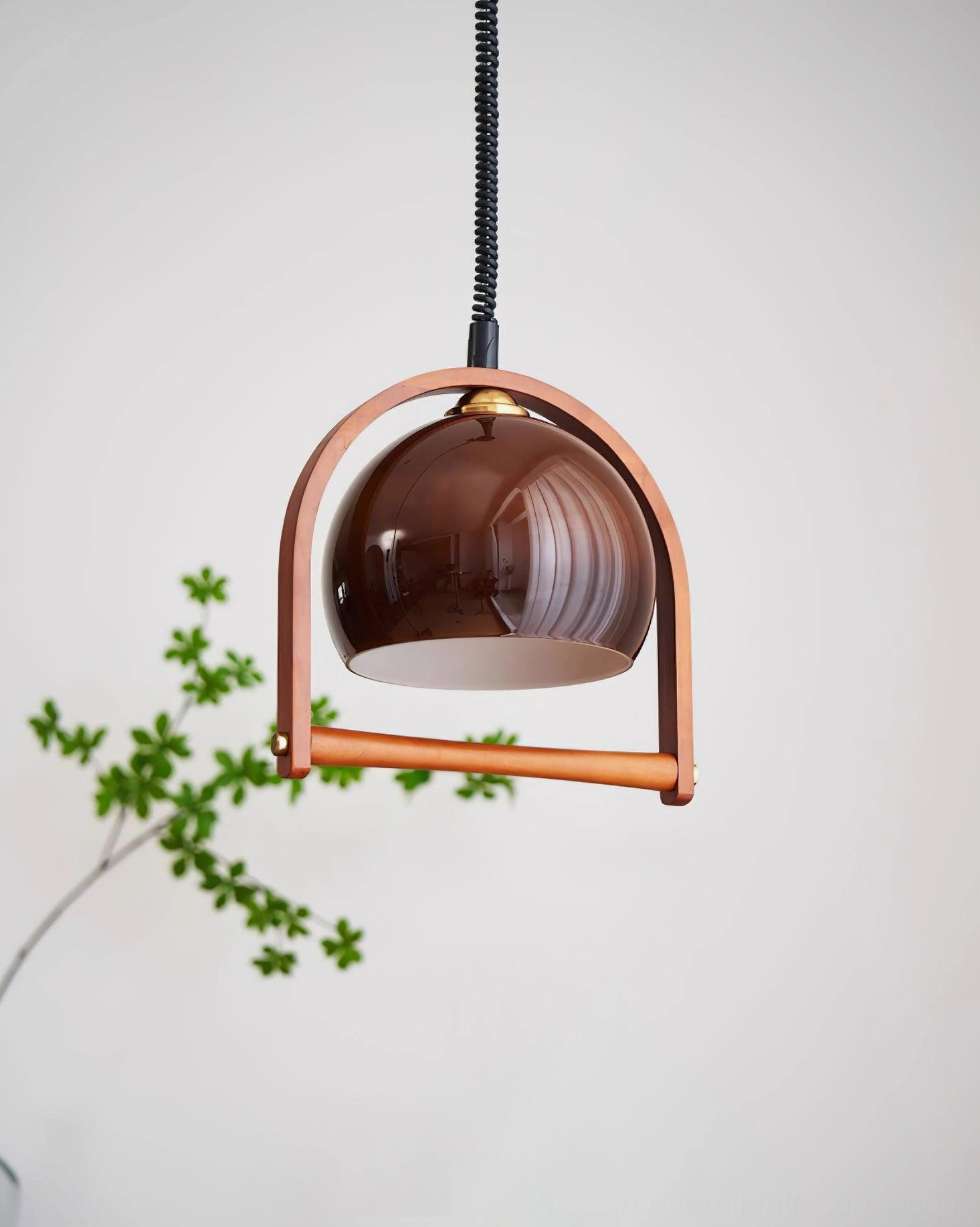 Kleine pendant lamp showing wooden arched frame detail and glass shade construction