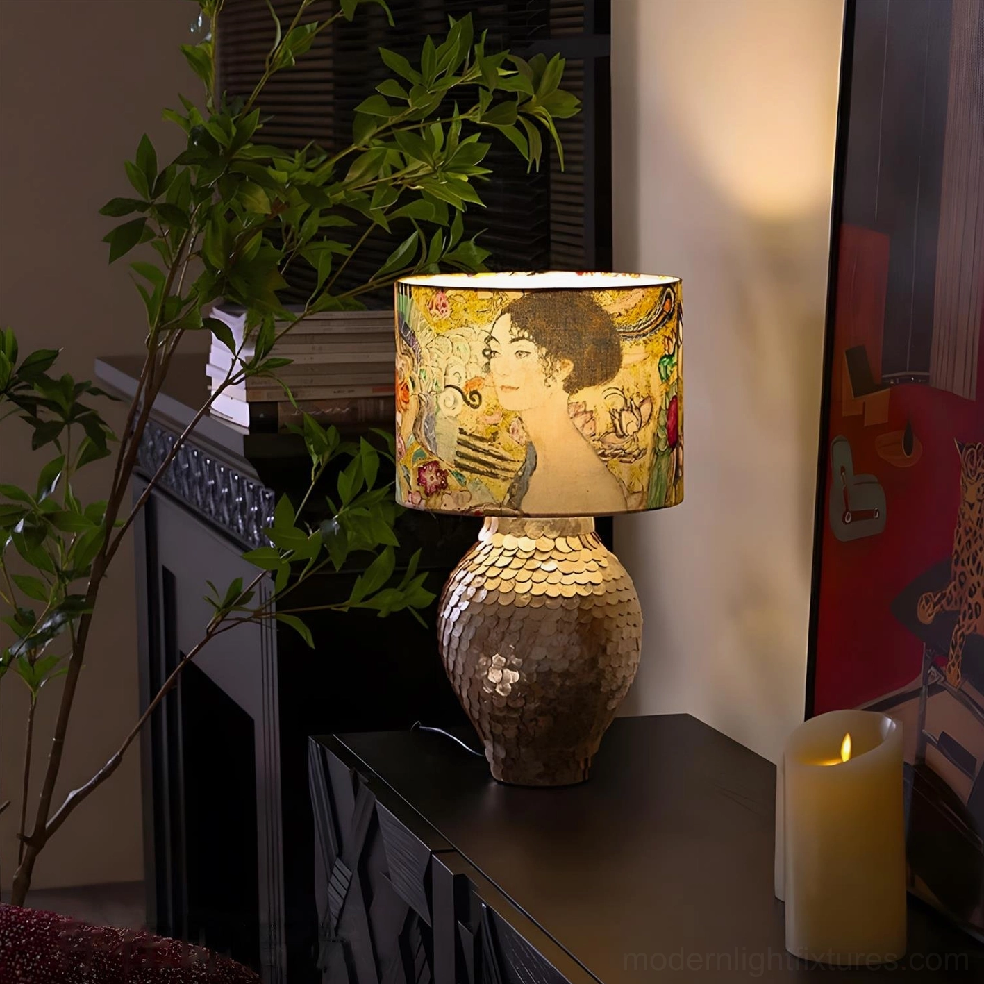 Klimora decorative lamp on modern fireplace side table with lit pillar candle and green foliage in warm glow