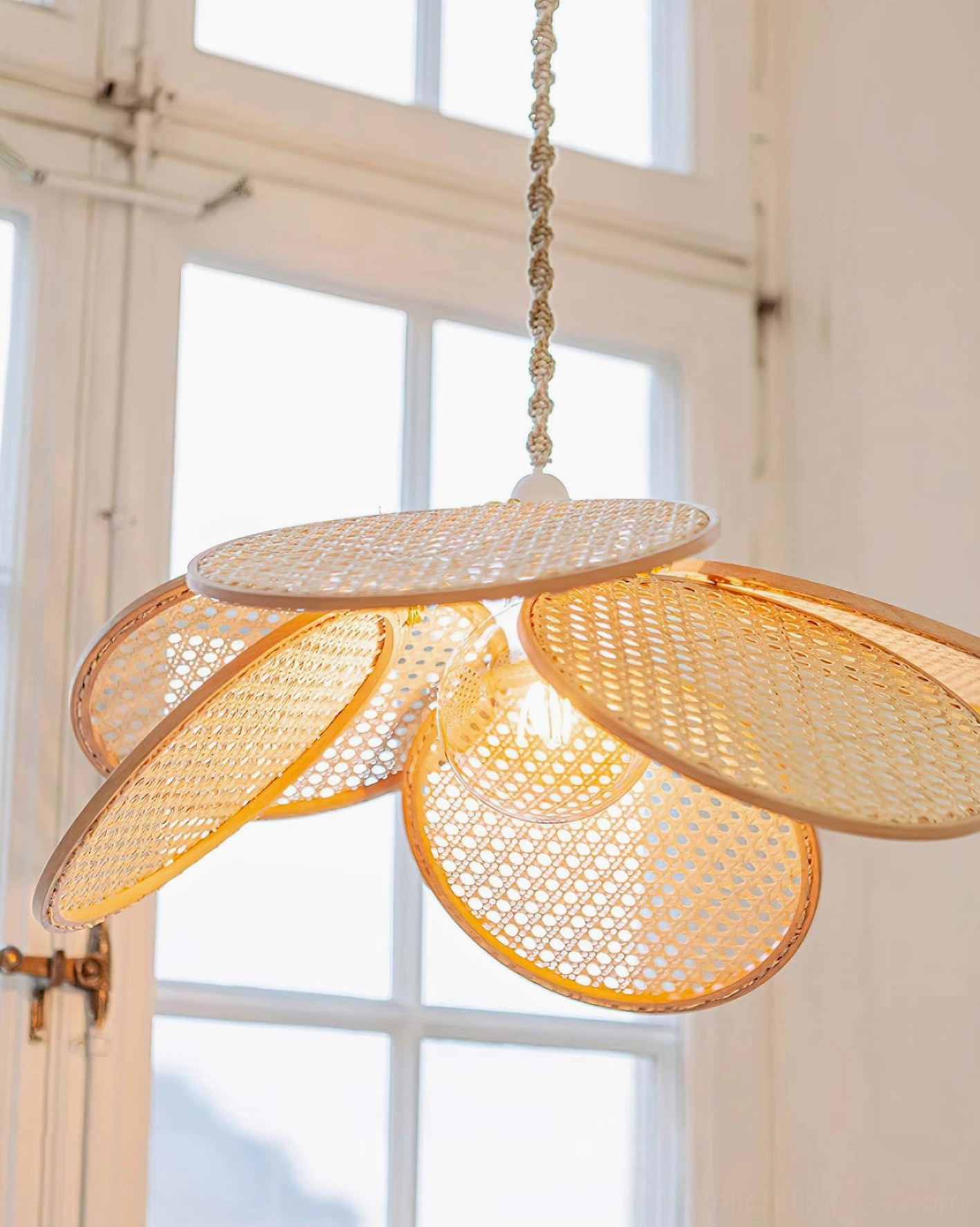 Kloe petal pendant lamp from below showing exposed Edison bulb and intricate rattan petal weaving pattern