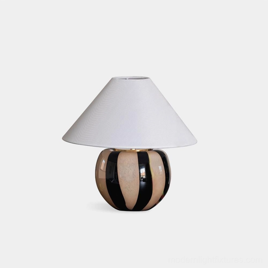 Kodhi modern ceramic striped table lamp with black and taupe bands, white linen conical shade, studio front view