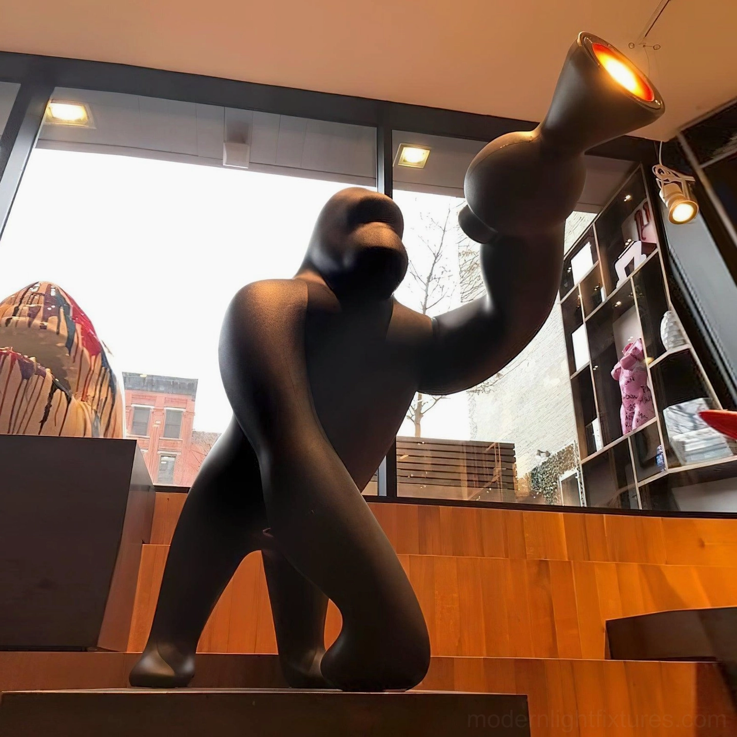 Kong floor lamp as artistic focal point in modern loft apartment with industrial design elements and open floor plan