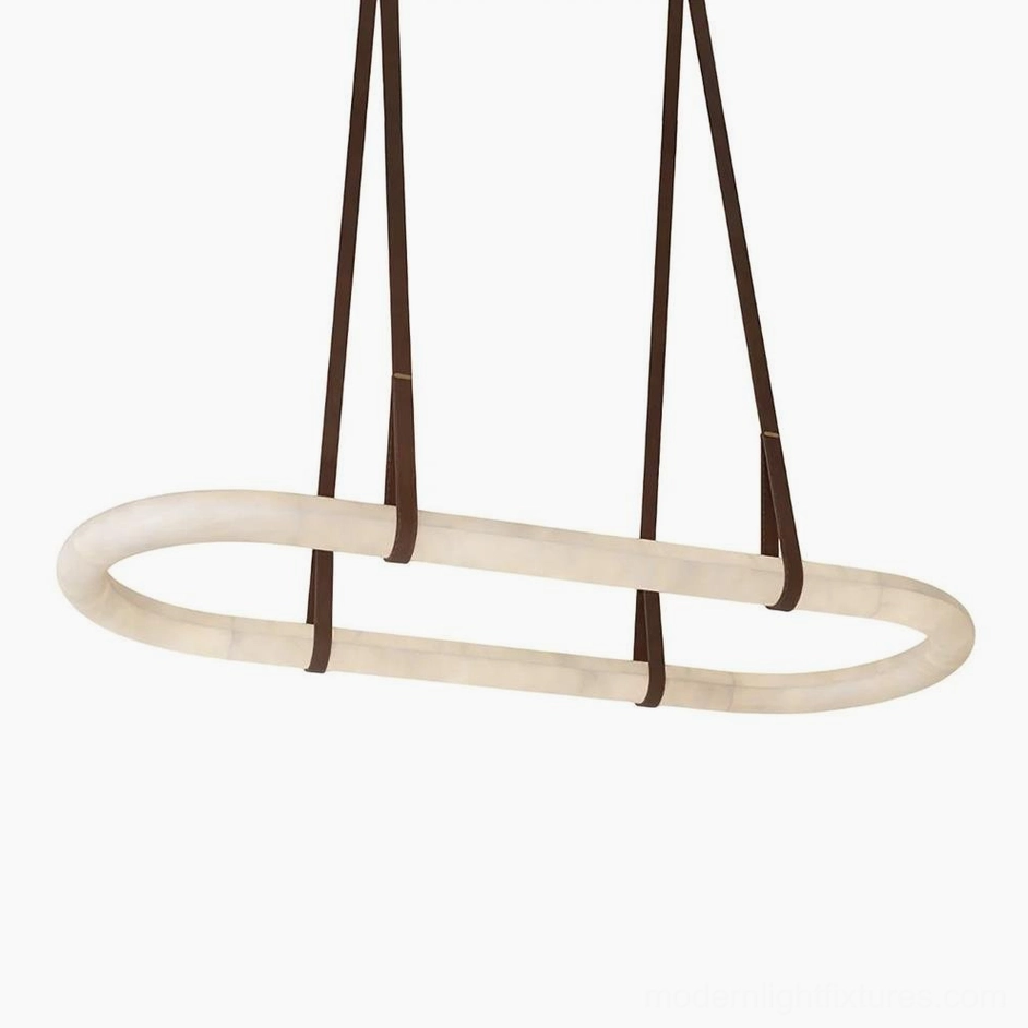Oval alabaster pendant chandelier suspended above wooden dining table in coastal dining room with brown leather straps