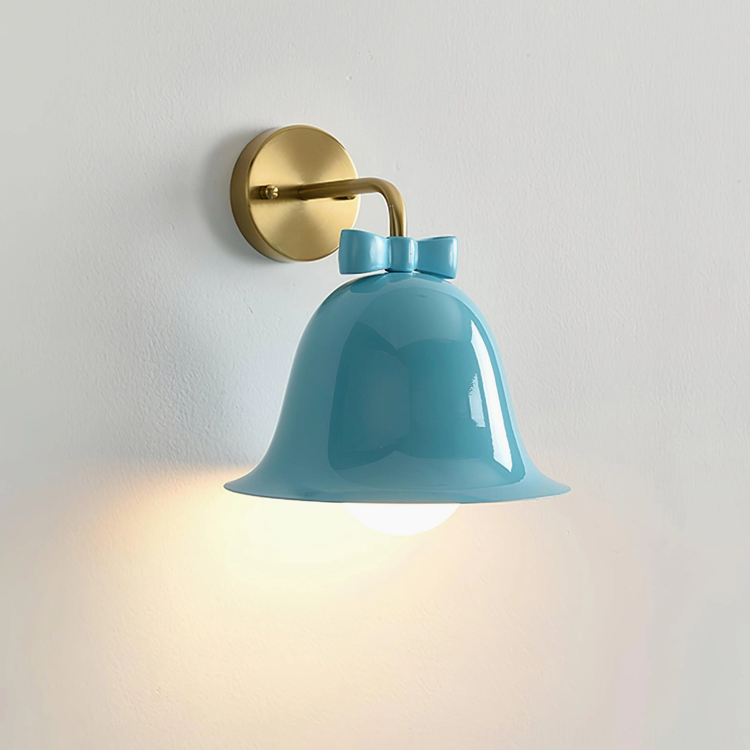 Lake blue bell-shaped wall lamp with brass bracket and bow knot accent on white background