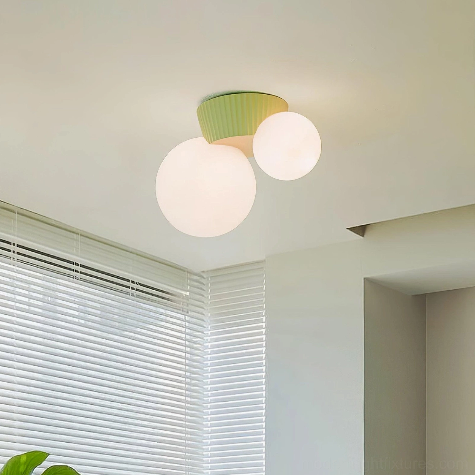 Land ceiling fixture with green ribbed resin base and frosted white glass shades installed in residential room