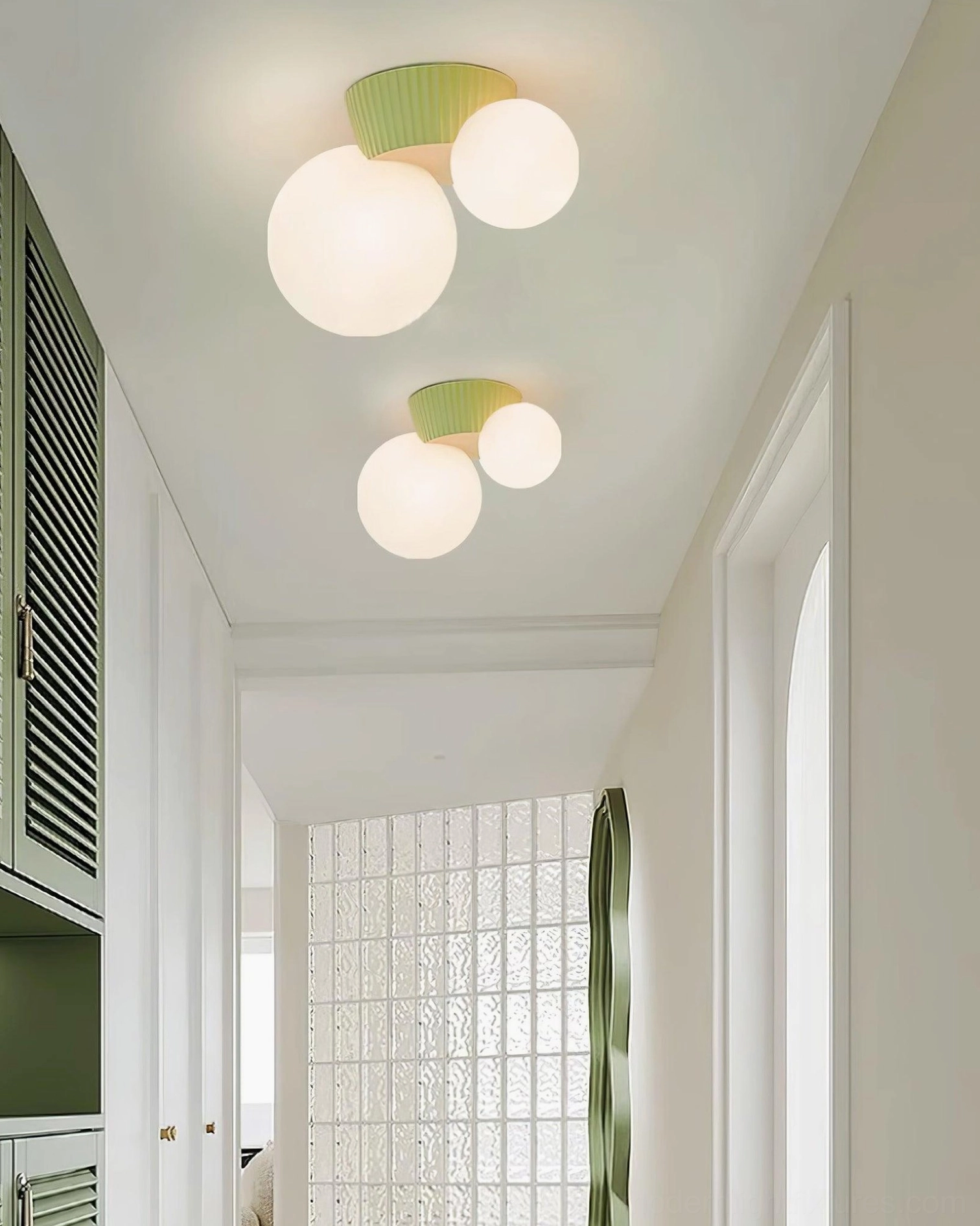 Multiple Land ceiling light fixtures with green textured bases creating gallery-style hallway lighting