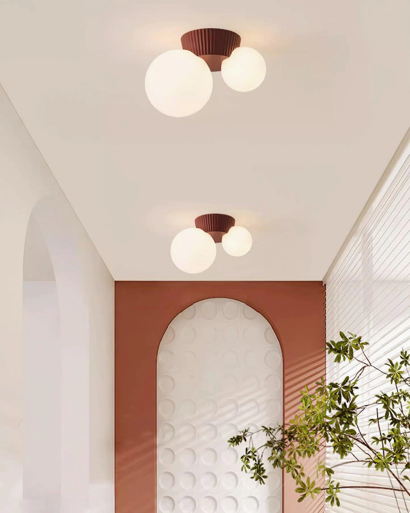 Land white glass shade ceiling light with sculptural resin base in bright modern room