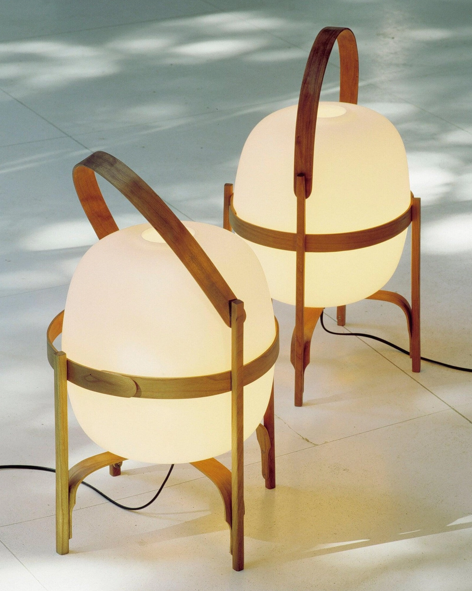 Modern portable lantern lamp showcasing wood and glass materials in natural light