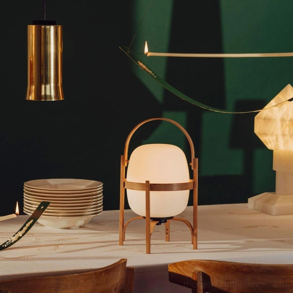Portable lantern lamp creating ambient lighting in reading nook area