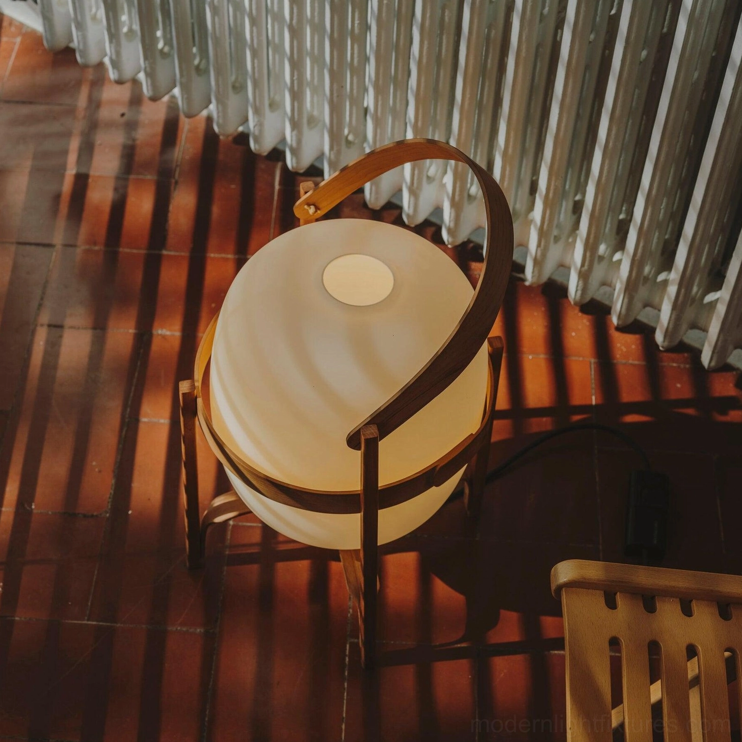 Portable lantern glass table lamp glowing softly in evening ambiance