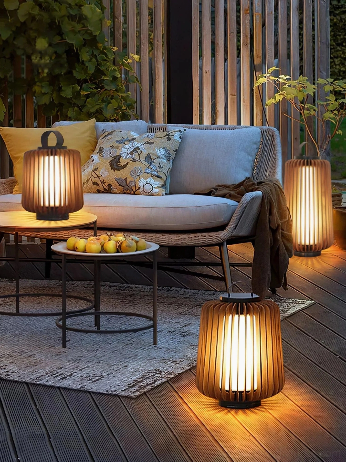 Wide view backyard patio lounge area with multiple Lanvera portable table lamps warm atmosphere