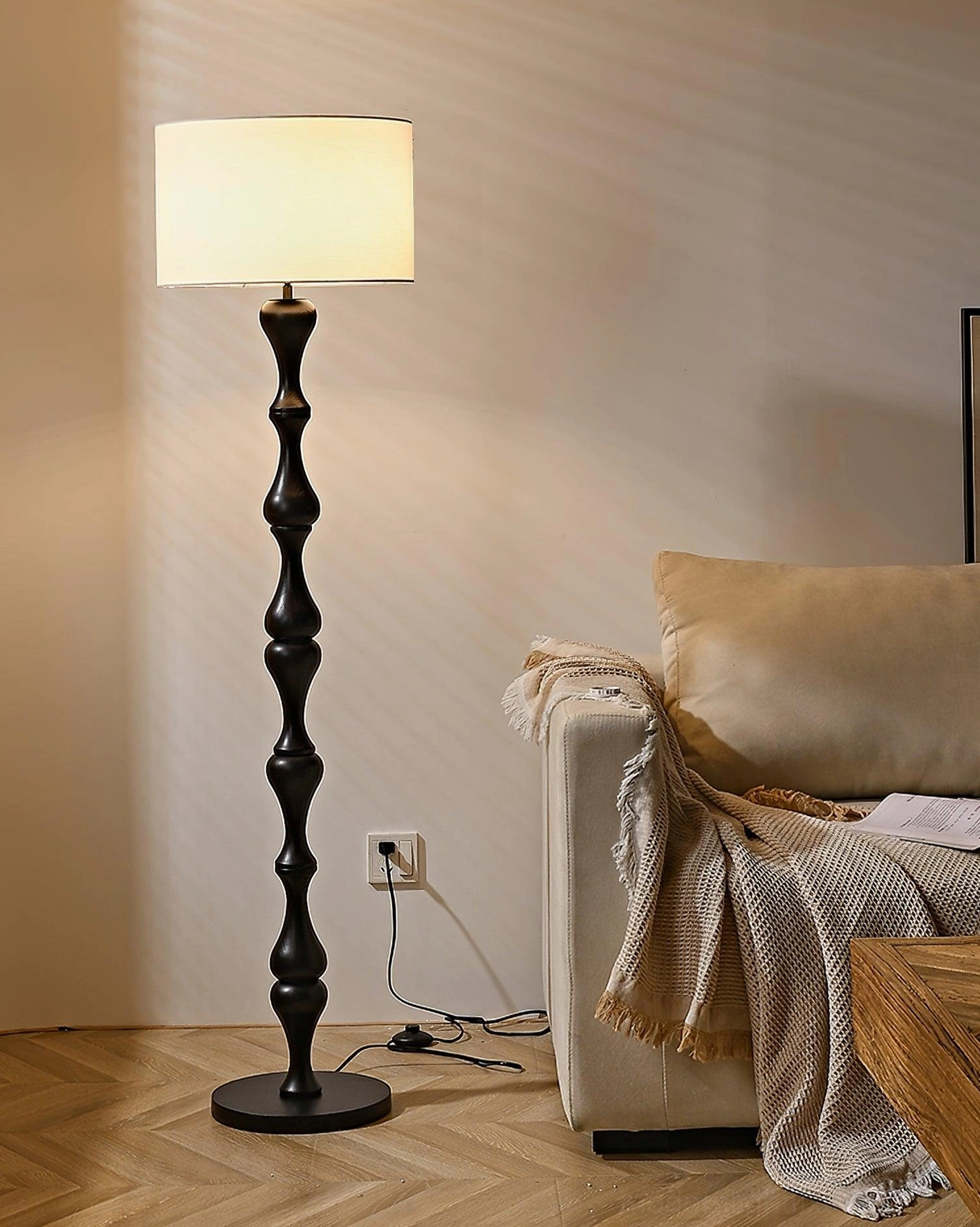 Laredo handcrafted floor lamp dark carved wooden base next to sofa seating area