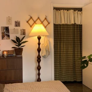 Laredo vintage floor lamp in bedroom with warm glowing light and pleated fabric shade