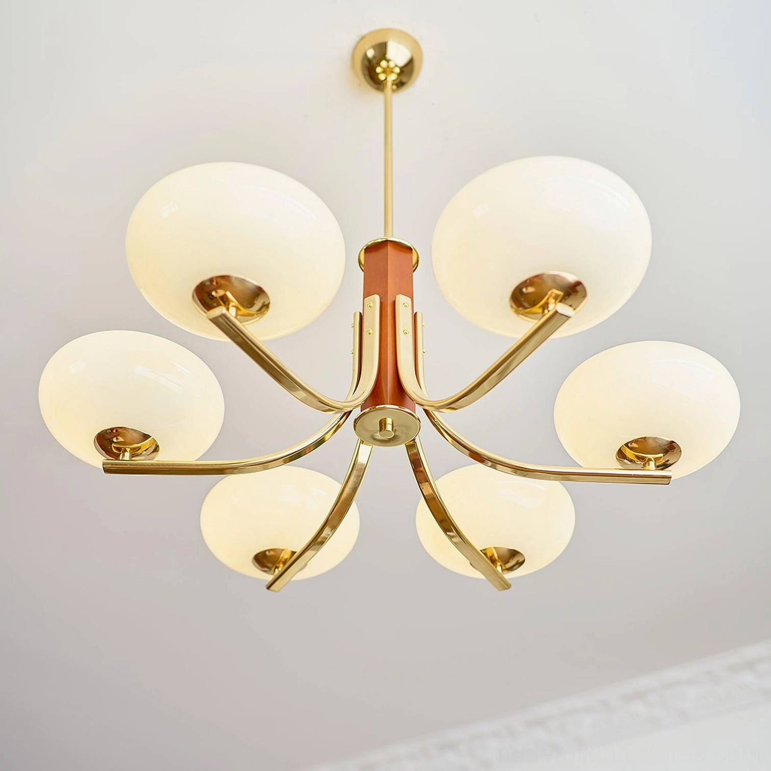 8-head mid-century modern sputnik chandelier with brass and wood construction displayed in plain white studio background