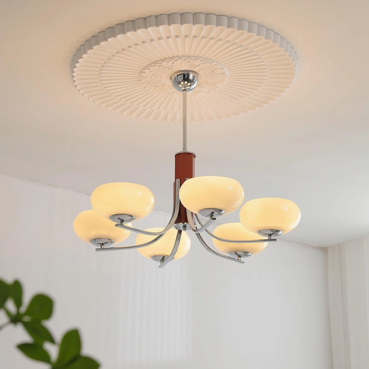 Larenta Rico chandelier with brass and wood materials displayed in contemporary interior setting with warm illumination