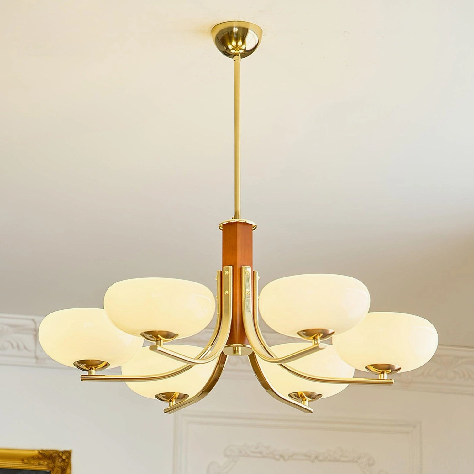 Mid-century modern 8-head pendant chandelier installed in French-style living room with brass finish and wooden details, vintage elegant ambiance