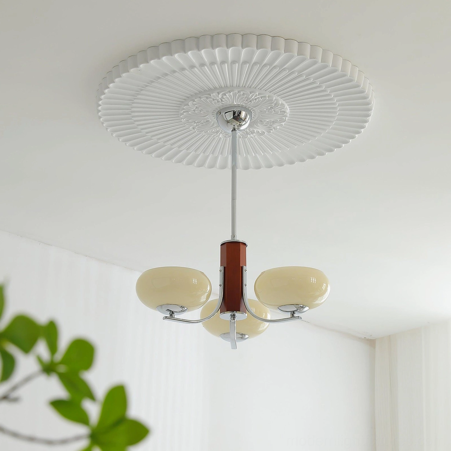 3-light compact pendant chandelier with wood central stem and brass finish displayed in bright minimalist living room with ceiling medallion