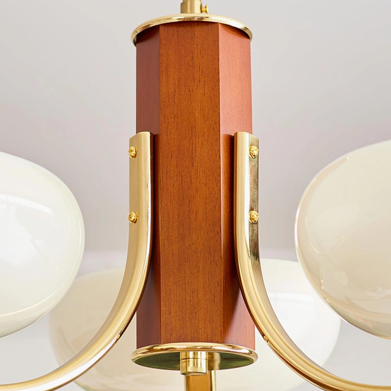 Larenta Rico mid-century modern chandelier with mixed metal and wood construction showing retro-modern design details