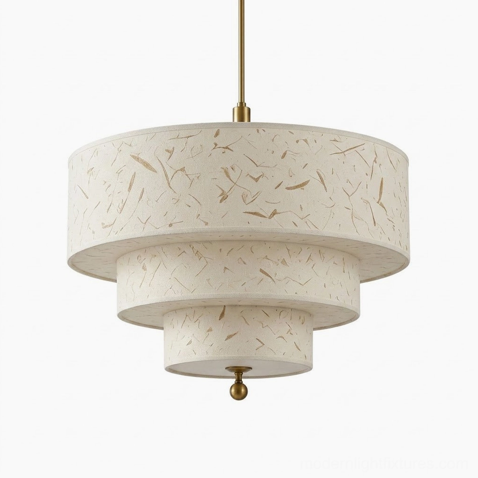 Large three-tier cascading drum pendant in handmade cream fiber paper with brass-tone hardware and finial, studio display